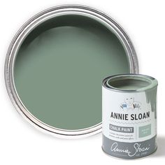 a can of annie sloan chalk paint next to it's green tint on a white background