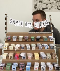 a man standing behind a display of small business cards