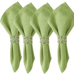 four green napkins with silver rings on them