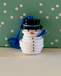 a snowman made out of plastic cups sitting on top of a counter