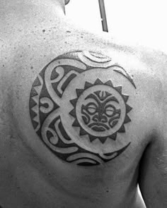 a man with a sun tattoo on his back