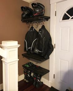 a pair of skis and snow shoes are hanging on the wall next to a coat rack