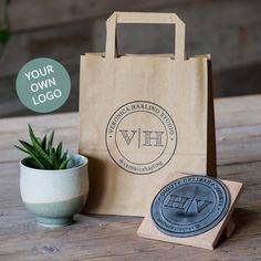 a brown paper bag sitting on top of a wooden table next to a potted plant