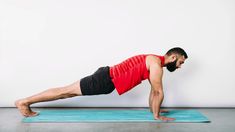 a man doing push ups on a blue mat