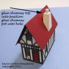 a close up of a small house made out of paper with the words glue chimney top