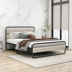 a bedroom with marble walls and flooring is pictured in this image, there is a bed that has two pillows on it