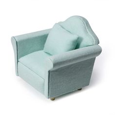 a light blue chair with a pillow on it's back and legs, sitting in front of a white background