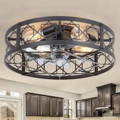 a kitchen area with a ceiling fan and light fixture