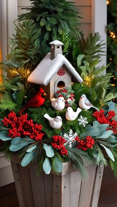 a planter filled with christmas decorations and birds