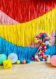 an image of a birthday decoration with balloons and streamers