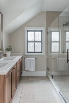 a large bathroom with two sinks and a shower