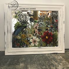 a white frame filled with lots of flowers