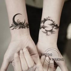 two people holding hands with tattoos on their wrist and the moon in the sky behind them