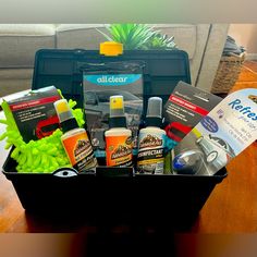 a black container filled with cleaning products on top of a wooden table