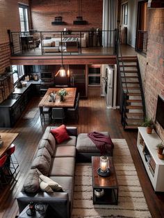 a living room filled with furniture and a fire place next to a loft style kitchen