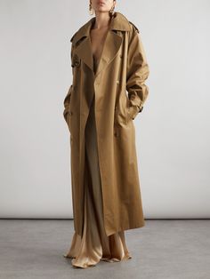 When it comes to trans-seasonal dressing, there's no better investment than a classic trench coat. SAINT LAURENT's iteration is made from cotton-twill and has the typical shoulder epaulettes, generous storm flap and double-breasted front. The detachable belt allows you to cinch the oversized shape, while the dark-sand shade will go with just about everything in your closet. Shoulder Epaulettes, Oversized Trench Coat, Flat Dress Shoes, Floral Dresses Short, Classic Trench Coat, Sport Swimwear, Sports Skirts, Jo Malone London, Swimsuit Dress