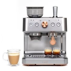 an espresso machine with two cups of coffee next to it on a white background