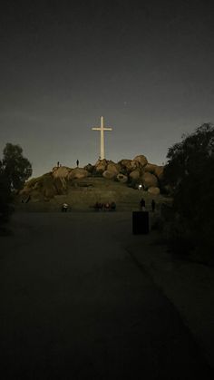 a cross on top of a hill at night