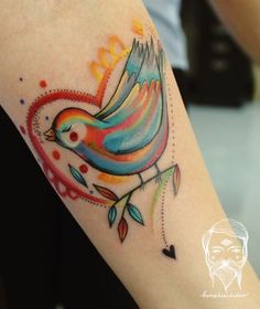 a colorful bird tattoo on the arm with hearts and arrows around it's wings