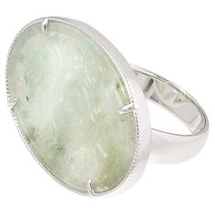 Jade of Yesteryear East-West Oval Carved Jade Ring Bring a touch of tradition to your jewelry collection with this carved jade ring. The east-west orientation and oval shape ensure a comfortable fit on any finger, while the green jade adds a subtle color pop to any outfit.       Approx. 13/16"L x 1-1/4"W x 1/8"H; shank 3/16"W     Stamped .925 sterling silver; rhodium plating   Stone Information       All sizes and weights approximate     Green Jade - Oval (20.4x30mm) Oval Jade Rings For Anniversary, Jade Rings With Polished Finish, Oval Cabochon, Jade Rings With Polished Finish In Oval Cabochon Shape, Jade Oval Cabochon Rings With Polished Finish, Oval Cabochon Jade Rings With Polished Finish, Round Jade Jewelry With Large Stone, Oval Jade Ring For Wedding, Oval Jade Wedding Ring, Oval Carved Jade Jewelry