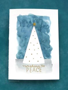 a card with a christmas tree on it and the words wishing you peace written in gold