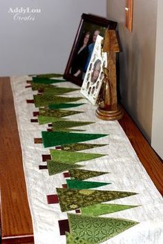 a long table runner with green trees on it