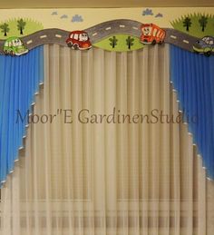 a curtain with cars and trucks on it in front of a window that says moore's garden studio