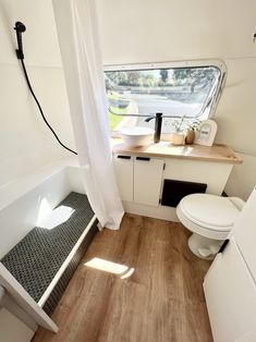 the bathroom is clean and ready to be used as a camper or home office