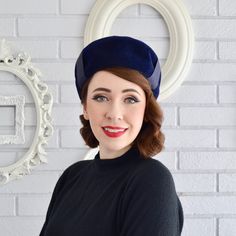 This vintage hat is classic and chic! Made of wool, the dark muted blue hat is adorned with a ribbon and bow on the top.  Measures 21" around the inside (no stretch). Fits most comfortable on a smaller head size.  Maker : Merrimac; Velour Regale; Union-Made.  Time Period : 1950's/1960's. Condition : Good.. There's light wear on the wool, light dirt wear/fading throughout the ribbon and bow, and the hat has indents around the sides of the ribbon due to the ribbon being tightly attached (just how Blue Formal Winter Hat, Formal Blue Winter Hat, Vintage Navy Flat Cap, Vintage Blue Hat For Formal Occasions, Vintage Blue Formal Hat, Blue Winter Cloche Hat, Hat With Ribbon, Muted Blue, Vintage Hat