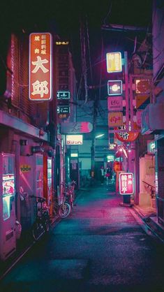 an alley way with neon signs on the buildings