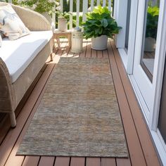 an outdoor area rug on a wooden deck