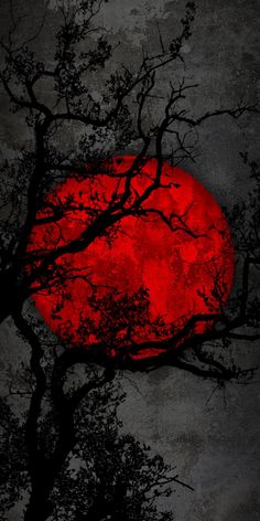 a red moon is seen through the branches of a tree in front of a dark sky