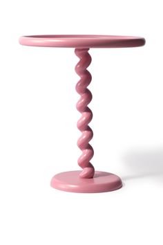 a pink table with spiral design on it's top and bottom, against a white background