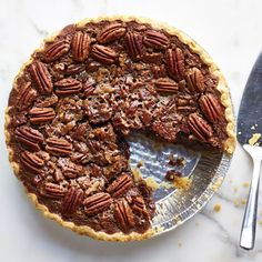 a pecan pie with one slice missing from it