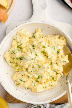 a white bowl filled with mashed potatoes on top of a table