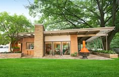 a modern house with an orange cone in the yard