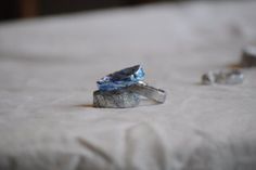 a diamond ring sitting on top of a bed