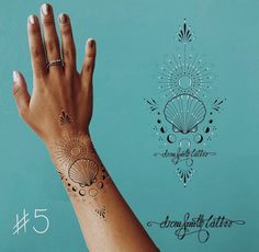 a woman's hand with tattoos on it and the number five in front of her