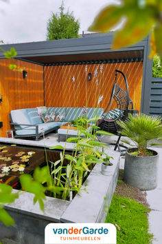 an outdoor living area with plants and furniture