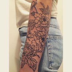 a woman's arm with flowers on it