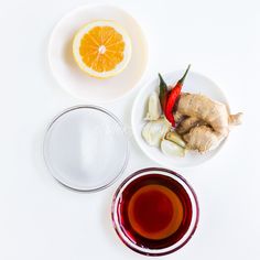 a white table topped with plates and bowls filled with food