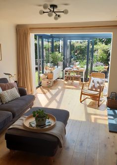 a living room filled with furniture and a sliding glass door that leads to a patio