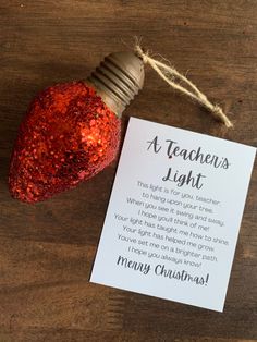 a teacher's light bulb with a note attached to it