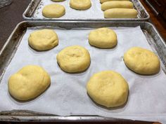 six uncooked doughnuts sitting on top of a baking sheet