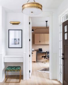 an open door leading to a room with a desk and chair in the corner,