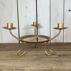 two candle holders on a wooden table