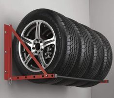 a car tire is mounted to the side of a wall with two red bars on it