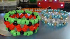 two bracelets sitting on top of a table next to each other with different colored beads