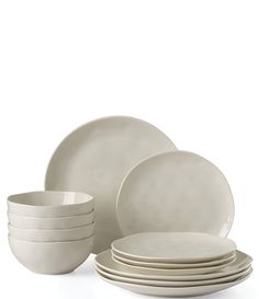 a stack of white plates sitting next to each other