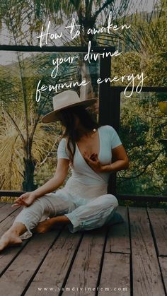 a woman sitting on top of a wooden deck wearing a cowboy hat and white pants